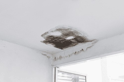 Pată de umezeală pe tavan cauzată de infiltrații prin acoperiș